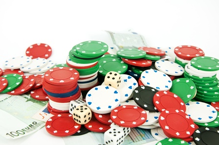 chips for roulette and dice on a white backgroundの写真素材