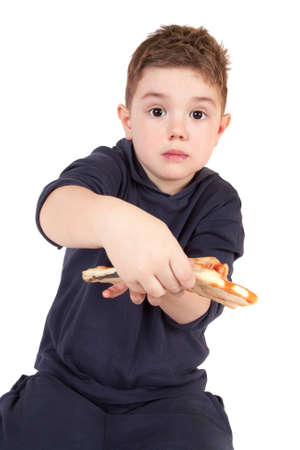 A young boy eating pizzaの写真素材