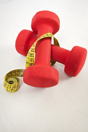 Dumbbell and measuring tape isolated on whiteの写真素材