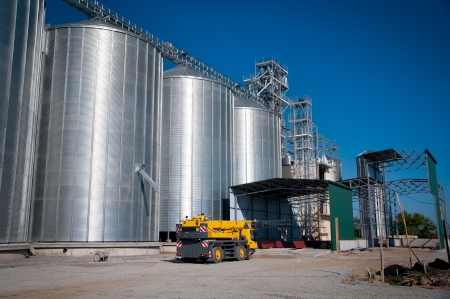 Silver Grain Silos with blue sky in backgroundの写真素材