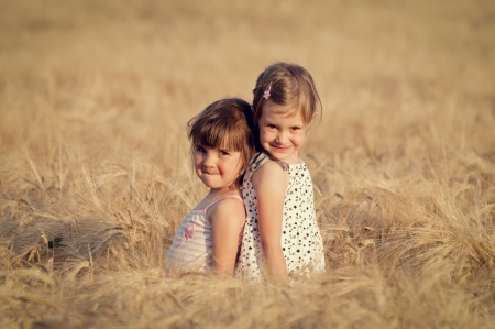 Happy girl in the field of wheat on sunny dayの写真素材