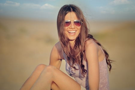 Girl sitting on the beachの写真素材
