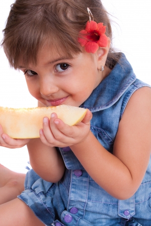Little smiling girl eating watermelonの写真素材