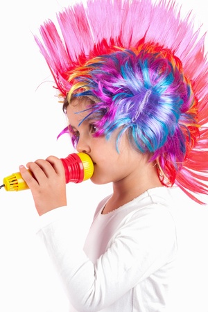 The children sing with colorful wigsの写真素材