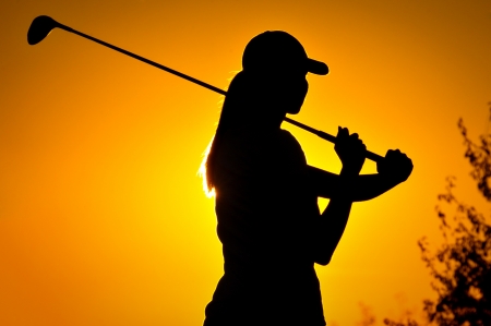 Female golfer at sunriseの写真素材