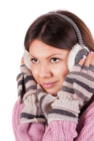 A beautiful young woman dressed for winter, over a white background の写真素材