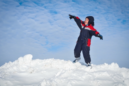 Happy little kid is playing in snowの写真素材