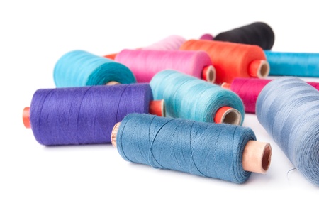 Colorful thread bobbins, isolated on white background 