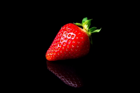 fresh strawberries isolated on black backgroundの写真素材