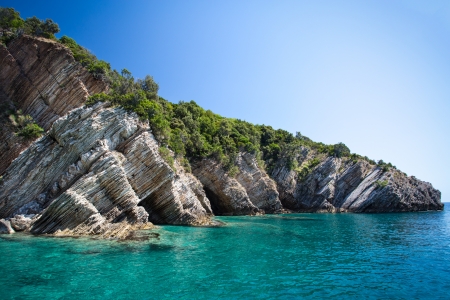 layered rocks and clear seaの写真素材