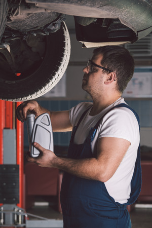 Car mechanic working in auto repair serviceの写真素材