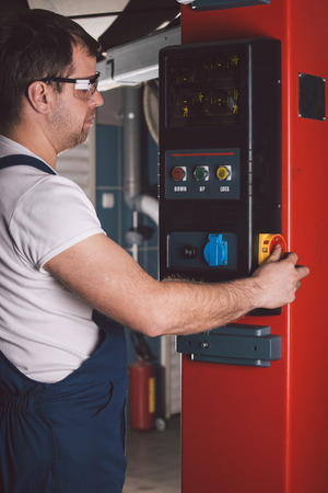 Car mechanic working in auto repair serviceの写真素材
