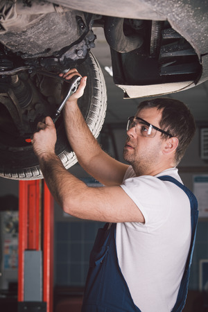 Car mechanic working in auto repair serviceの写真素材