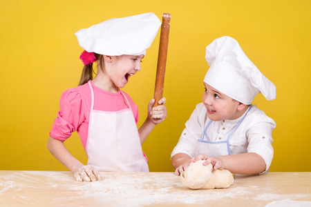Cheerful children cook pizzaの写真素材