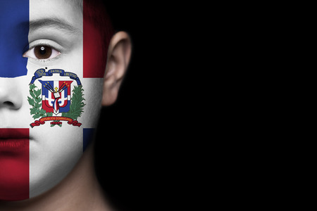 Human face painted with flag of Dominican Republicの写真素材