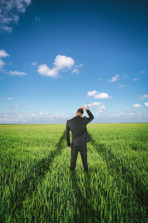 Businessman in a wheat fieldの写真素材