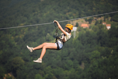 Adult woman on zip lineの写真素材
