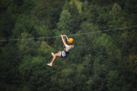 Adult woman on zip lineの写真素材