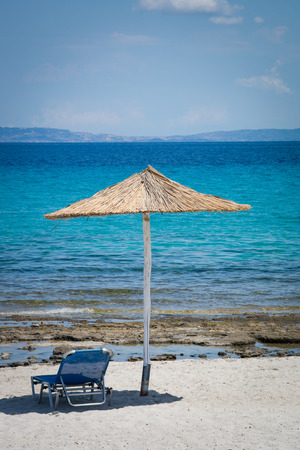 Beach chair and umbrella on  sandy beachの写真素材