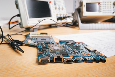 Tech tests electronic equipment in service