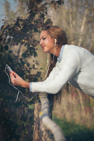 Young beautiful girl listening to musicの写真素材