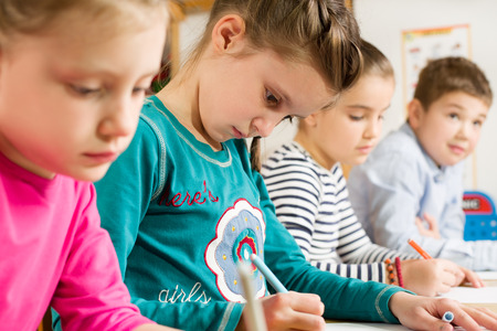 Junior pupils drawing with highlighters