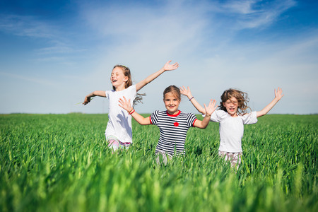 Little girls running on the fieldの写真素材