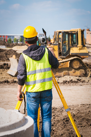 Surveyor engineer worker making measuring with theodolite tool equipment at construction siteの写真素材
