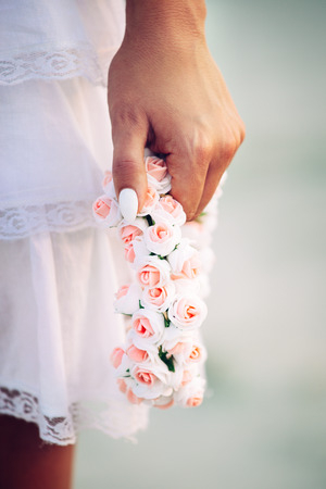 Holding flowers on a girl's handsの写真素材