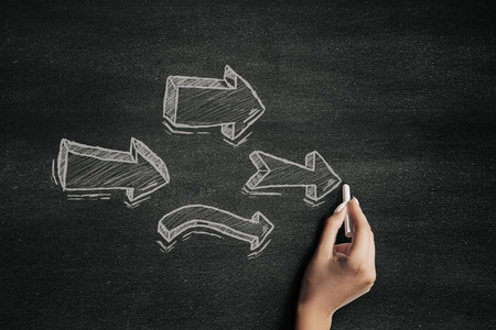 Chalk arrows on a blackboardの写真素材