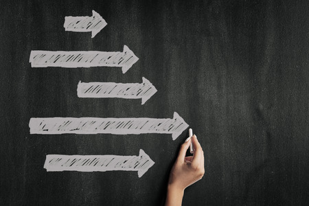 Chalk arrows on a blackboardの写真素材