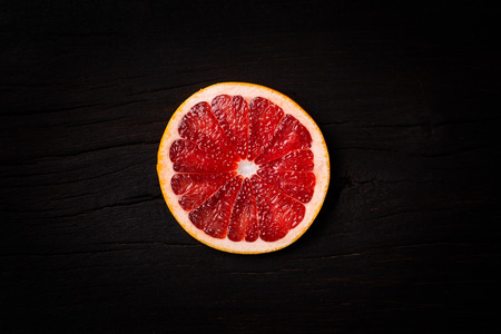 Red grapefruit on old tableの写真素材
