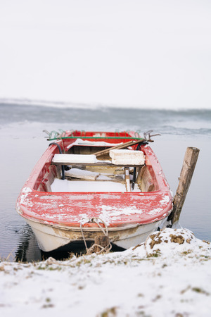 The boat in the winter on the freezing lakeの写真素材