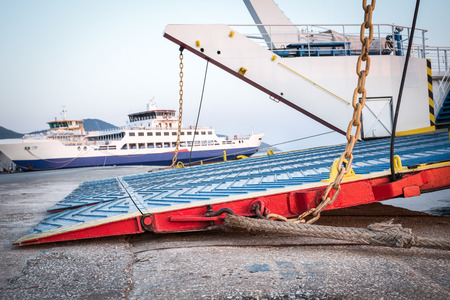 Passenger ferry in harbor with door open to take carsの写真素材