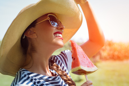 Beautiful girl eating fresh watermelonの写真素材