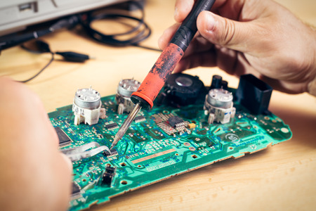 Tech tests electronic equipment in service center