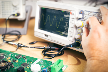 Engineer tests electronic components with oscilloscope in the service centerの写真素材