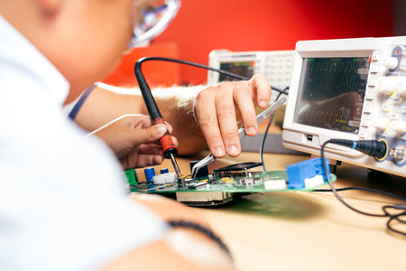 Young boy working on an electronics project