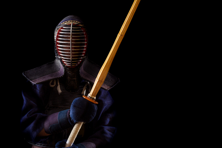Kendo warrior in traditional dress on a black backgroundの写真素材