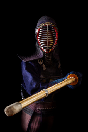 Kendo warrior in traditional dress on a black backgroundの写真素材