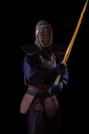 Kendo warrior in traditional dress on a black backgroundの写真素材