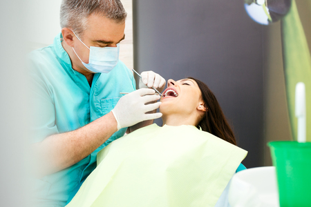 Woman receiving a dental treatmentの写真素材
