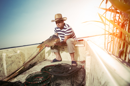 Fisherman Holding a Big Fishの写真素材