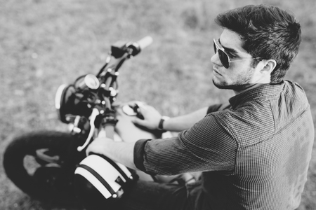 Young biker with his motorcycleの写真素材