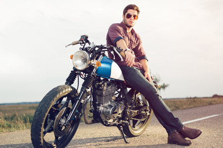 Young biker with his motorcycleの写真素材