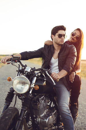 Sexy couple of bikers on the vintage custom motorcycleの写真素材