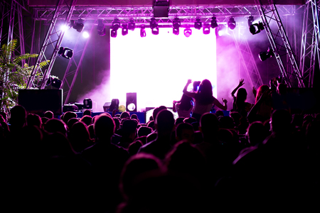 Crowd at concert and blurred stage lightsの写真素材