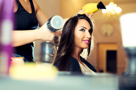 Woman getting her hair dried at the hair salonの写真素材