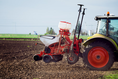 Farmer seeding crops at field