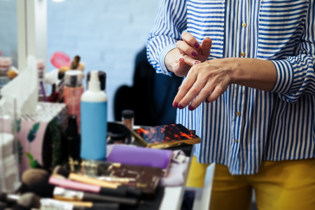 Female makeup artist with cosmetics at work close-upの写真素材